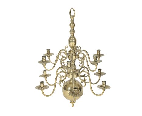 ANGLO-DUTCH BRASS TWELVE LIGHT CHANDELIER, circa 1725, the urn sockets and dished drip pans arranged in two graduated tiers o