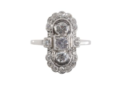 AN ART DECO DIAMOND CLUSTER RING, the three brilliant cut diamonds within a surround of brilliant cut and eight cut diamonds,