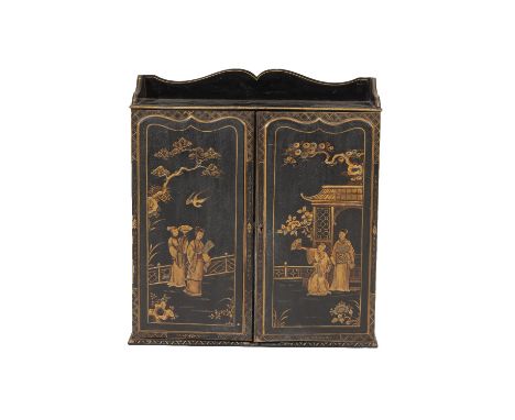 BLACK LACQUERED AND PARCEL-GILT WALL CABINET in Oriental 17th century style, the shelf top with serpentine three-quarter gall