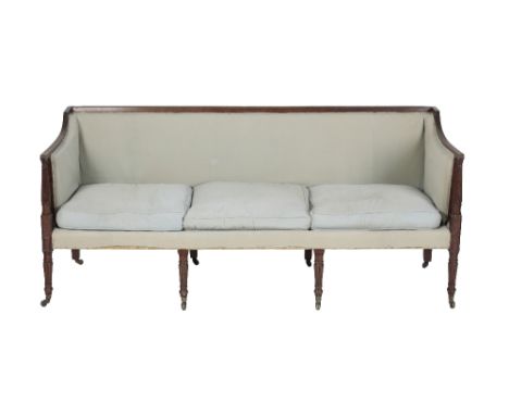 GEORGE III MAHOGANY AND UPHOLSTERED SOFA, circa 1800, with reeded toprails to the straight horizontal back and arm rests, a t