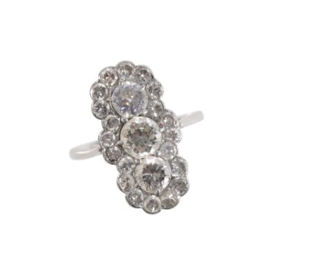 A THREE STONE DIAMOND CLUSTER RING, the three old brilliant cut diamonds, surrounded by a border of twenty brilliant cut diam