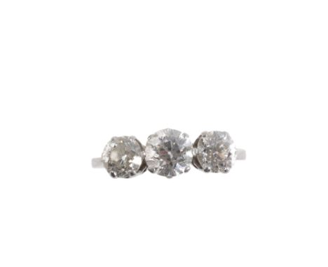 A THREE STONE DIAMOND RING, the three old brilliant cut diamonds, approximately 1.40 carats total, in claw settings, on a whi