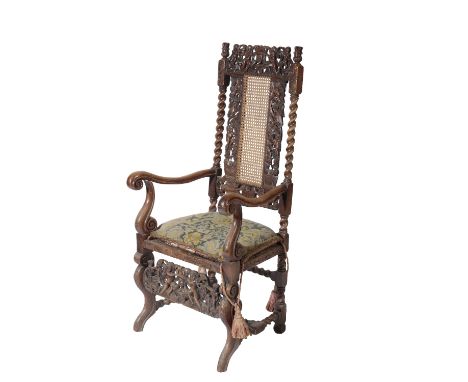 CARVED WALNUT, CANEWORK AND UPHOLSTERED ELBOW CHAIR, 19th century, in Charles II style, the carved and pierced top rail with 