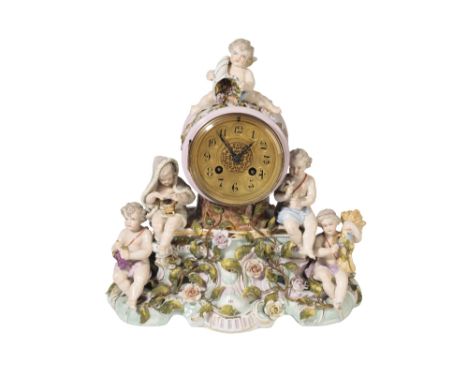 SITZENDORF PORCELAIN CLOCK GARNITURE, LATE 19TH CENTURY, the ornate foliate encrusted clock applied with cherubs emblematic o