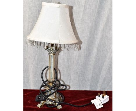 A lamp with cream shade and hanging teardrop elements. Decorative base with claw feet. H=42, W=21cm