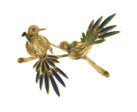 A ruby and enamel broochRealistically modelled to depict two peacock style birds perched on a branch, each bird set with ruby