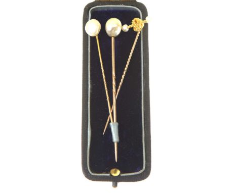 A pearl stick pinThe irregularly shape pearl approx. 9.4mm x 7.6mm, fitted to a rose metal stick pin, pearl untested, length 