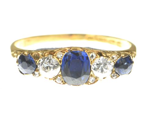 An early 20th Century sapphire and diamond five stone ringCentering an oval shape sapphire, flanked by old European cut diamo