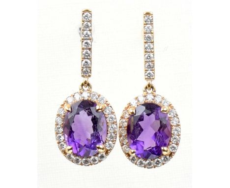 Mappin & Webb: A pair of amethyst and diamond cluster ear pendantsThe oval shape amethysts to a round brilliant cut diamond s