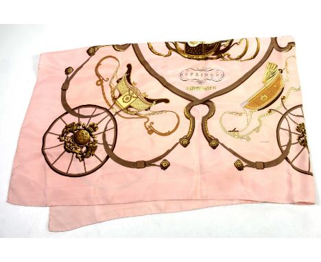 A Hermes 'Springs' silk scarf The pale prink ground scarf, detailed with carriages detailed in brown and ochre tones, 85cm x 