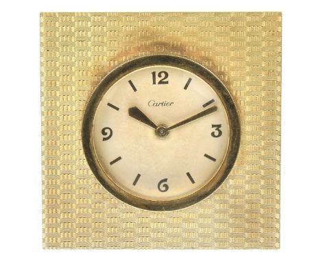 Cartier: A desk clockOf square form with engine turned weave decoration, the signed circular dial with gold tone baton and Ar