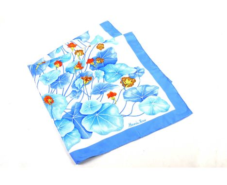 A Hermes silk 'Les Capucines' silk scarfThe white and pale blue ground scarf, picked out with orange flowers and foliage and 