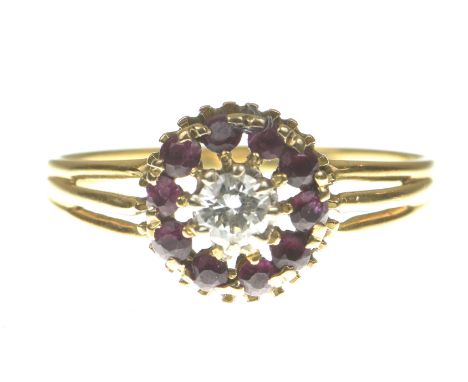 A ruby and diamond cluster ringCentering a round brilliant cut diamond to a circular shape ruby surround, modelled in preciou