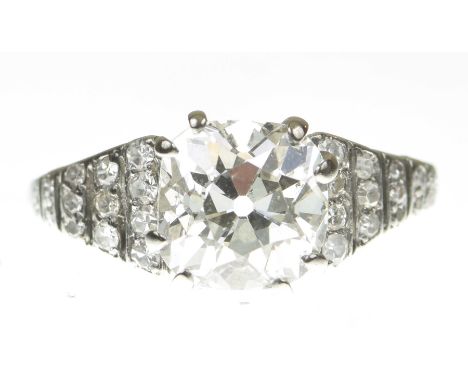 An impressive Art Deco diamond dress ringCentering a cushion cut diamond flanked by graduated stepped single cut diamond shou