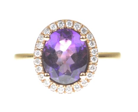 Mappin & Webb: An amethyst and diamond cluster ringThe oval shape amethyst within a round brilliant cut diamond surround, in 