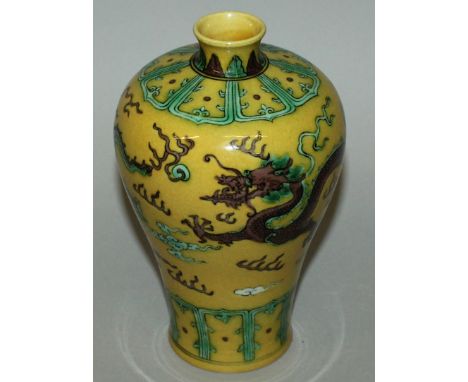 A CHINESE YELLOW GROUND PORCELAIN MEIPING VASE, decorated in green and aubergine with dragons amidst flame and cloud scrolls,