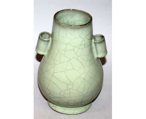 A CHINESE CELADON GLAZED CRACKLEGLAZE PORCELAIN ARROW VASE, of Hu form, the base with an incised mark, 8.1in high.