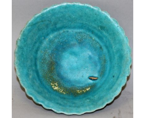 A SMALL CHINESE KANGXI PERIOD TURQUOISE GLAZED PORCELAIN DISH, the underside rim with a moulded lappet design, the base ungla