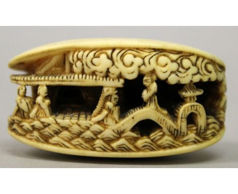 A JAPANESE MEIJI PERIOD IVORY NETSUKE OF THE CLAM'S DREAM, the clam opening to reveal a figural terrace and bridge scene, 1.8