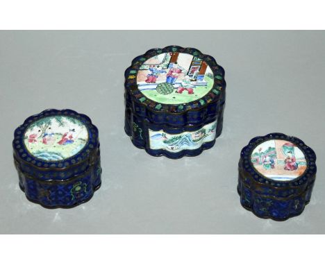 A GRADUATED SET OF THREE 19TH CENTURY CHINESE CANTON ENAMEL BOXES & COVERS, of lobed section, each cover with a figural garde