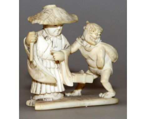A SIGNED JAPANESE MEIJI PERIOD IVORY NETSUKE, in the form of a man in a wide brimmed hat standing in the company of an oni de