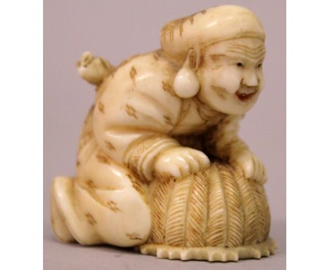 A JAPANESE MEIJI PERIOD IVORY NETSUKE OF DAIKOKU, leaning over a basket with a rat on his back, 1.5in high.