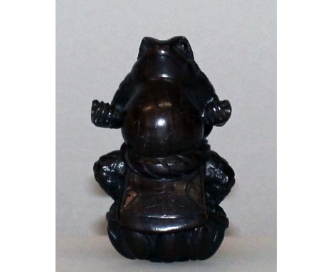 A SIGNED JAPANESE WOOD NETSUKE, in the form of a standing toad, 1.8in high.