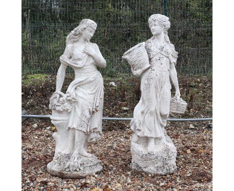 A pair of composite stone garden statues,20th century, modelled as two classical female figures wearing flowing robes on plin