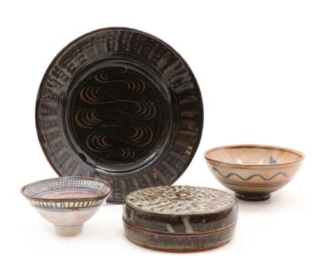 A collection of British studio pottery,comprising a stoneware dish, by Seth Cardew, with a combed decoration, a bowl by Aru C