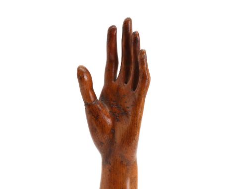 A Victorian polished pine model of an arm,possibly from a lay figure, previously used to display rings in a Welsh jewellery s