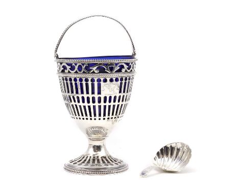 A George III silver sugar basket,London 1779, with a beaded swing handle leading to pierced decoration, with crest engraving,