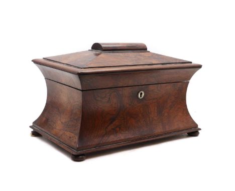 A Victorian rosewood tea caddy,of sarcophagus form, with mother of pearl escutcheon, the interior fitted with a moulded glass