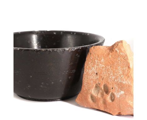 A large black marble bowl,probably from The Grand Tour, 22cm diameterand a Roman terracotta fragment, probably 1st or 2nd cen