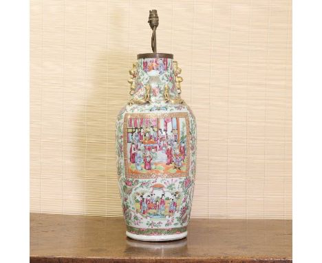 A Chinese Canton famille rose vase,late 19th century, painted with figures in shaped panels surrounded by sprigs of flowers a