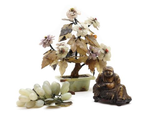 A Chinese hardstone model of a seated Buddha, 20th century on a carved hardwood base12cm hightogether with a Japanese hardsto