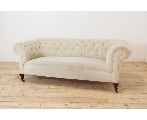 A Victorian button back synthetic suede chesterfield sofa,recently reupholstered in Impala Fabrics, raised on pad supports, w