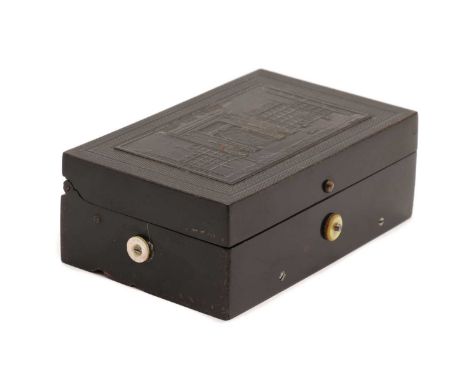 A musical snuff box,late 19th century, playing 3 airs within a Bakelite style moulded case, titled 'Port St Denis, complete w