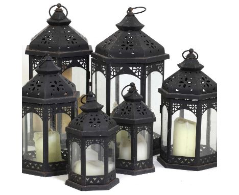 A group of five iron garden lanterns,20th century, of hexagonal shape, each with a hinged door and candle,43, 33 and 24cm hig