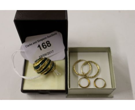 A yellow metal and green enamel decorated ring; together with two pairs of yellow metal era-rings 