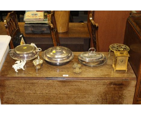 A brass trivet stand; a brass cased striking carriage clock; a small metal pig money box; a silver plated sauce boat; two ent
