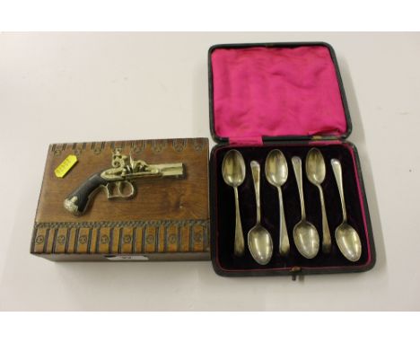 A set of six silver coffee spoons; and a wooden trinket box mounted with a pistol