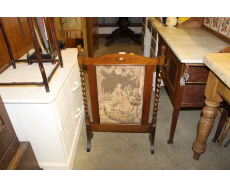 An oak barley twist and needlework firescreen