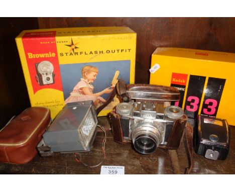 Braun Paxette camera, flash attachments, and a boxed Kodak Instamatic camera