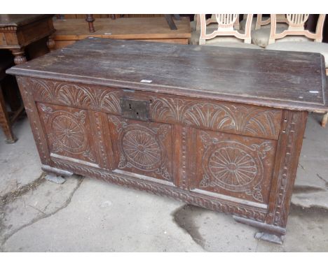 18th c carved oak coffer having three carved panel front, iron handles, original staple &amp; loop hinges standing on later o