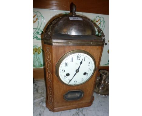 Light oak Arts &amp; Crafts table clock with ornate metal details, an enamel face, 8-day and striking on a bell, approx. 15" 