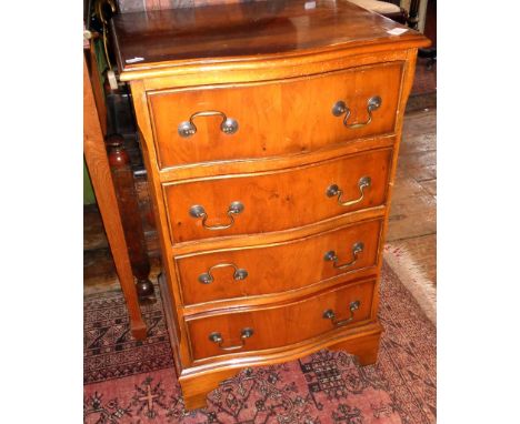 Serpentine front walnut-veneered narrow chest of four drawers on bracket feet