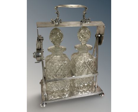 A late Victorian silver plated two bottled Tantalus, no key.