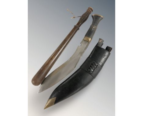 A turned wooden truncheon, length 38 cm, and a reproduction kukri in sheath.