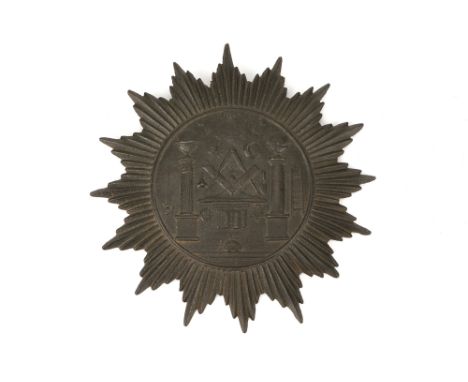 A cast iron plaque,  in the form of a star and with masonic designs, with suspension ring, diameter 16cm. Provenance: Formerl