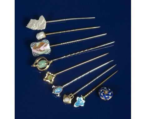 A Murrle Bennett silver stick pin, with shield terminal set with an opal, a Child & Child stick pin set enamelled with a mapl